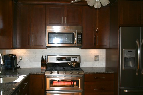 New Caledonia Granite Countertops Dark Cabinets Unique Grain Structure  Brown